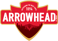 Arrowhead brand logo featuring a red shield with a mountain and forest silhouette and the year 1894.
